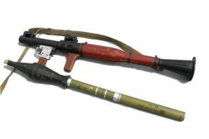 A rocket-propelled grenade (left) and RPG-7 launcher. For use, the thinner cylinder part of the rocket-propelled grenade is inserted into the muzzle of the launcher.