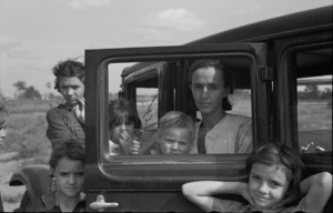 The family of a migratory fruit worker from Tennessee now camped in a field near the packinghouse at Winter Haven, Florida, 1937. Photo: Rothstein, Arthur, 1915-1985, photographerUnited States. Resettlement Administration. Library of Congress Public Domain